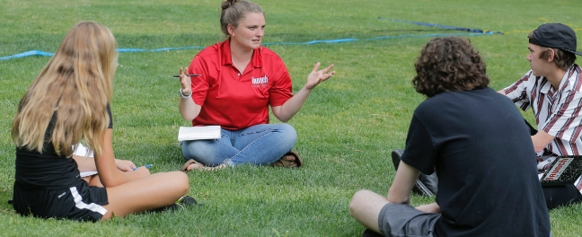 homepage-registerforlaunch-launch2 launch instructor talking to group of three students